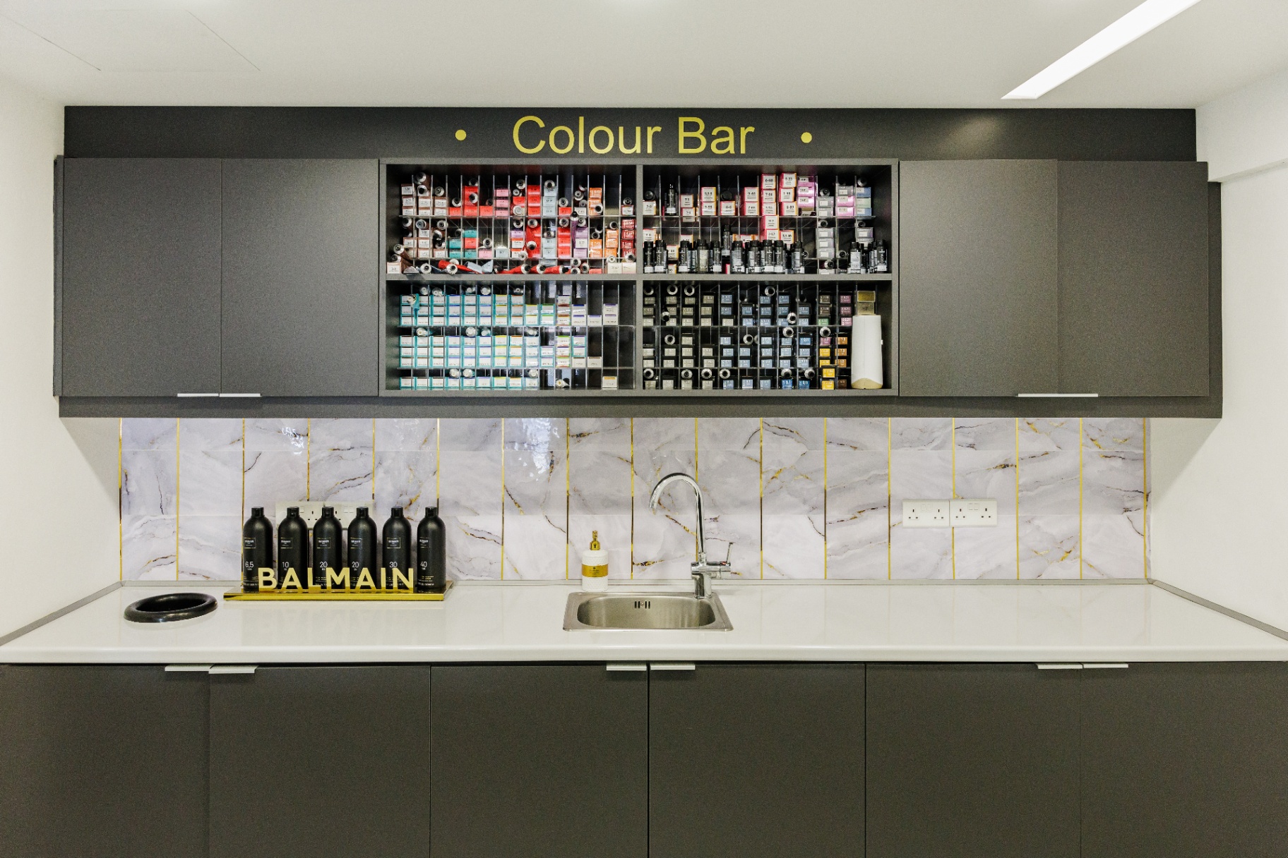 The dedicated Color Bar shelving with Balmain, Kérastase and Moroccanoil products